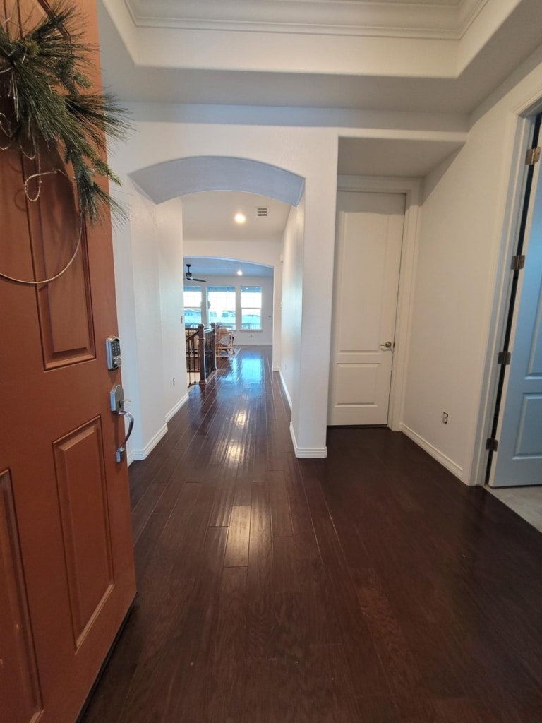 Bright arched hallway with fresh white walls, interior painting in Westminster, CO by Imperial Painters