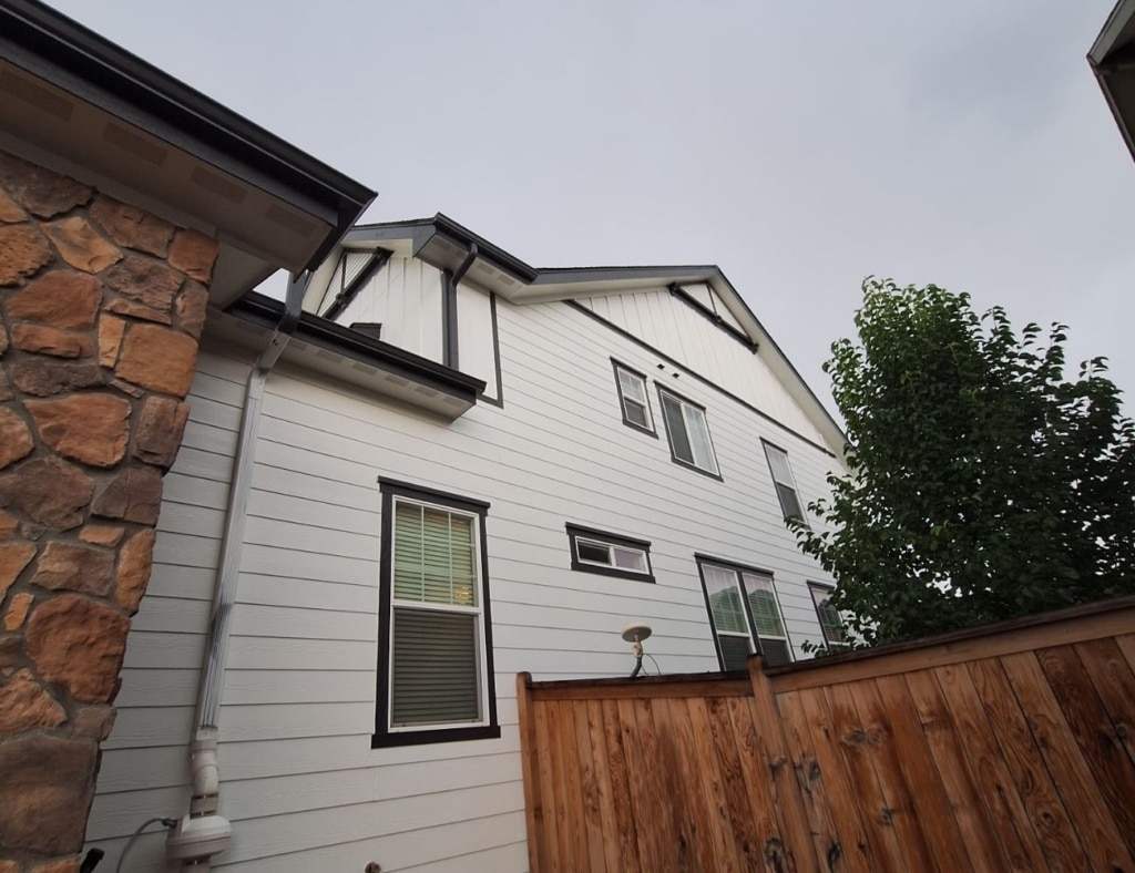 Experienced painter inspecting wall finish and crisp cut-in lines indoors. Painting Company Near Me.