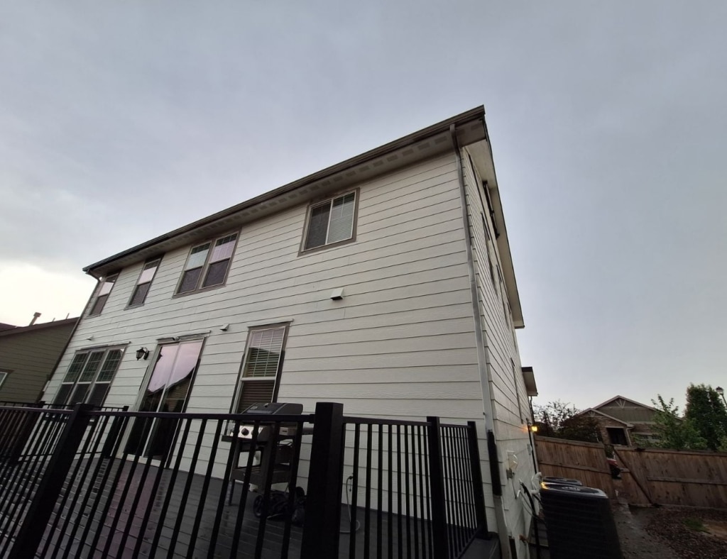 Experienced painter preparing weathered trim and siding with careful exterior repair steps